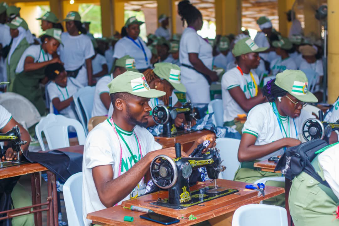 NYSC corps members practising sewing during an Aburoff Trend SAED session